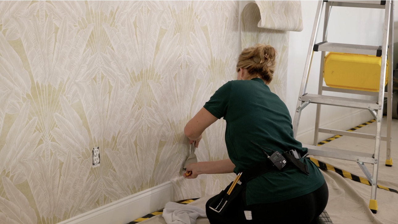 Wallpaper installation detail with a professional installer applying wallcovering